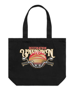 Black tote bag with design of the words destination unknown in front of a sunset, with motorbike handlebars on black wide tote bag
