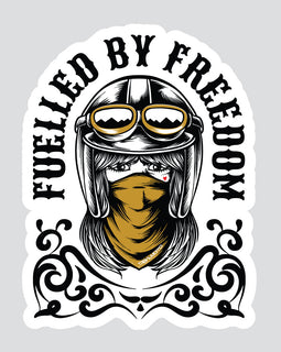 A die-cut sticker featuring a stylized illustration of a woman in a black aviator helmet with goggles and a mustard yellow bandana, with the text 'FUELLED BY FREEDOM' arched above her on a light gray background.