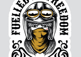 A die-cut sticker featuring a stylized illustration of a woman in a black aviator helmet with goggles and a mustard yellow bandana, with the text 'FUELLED BY FREEDOM' arched above her on a light gray background.