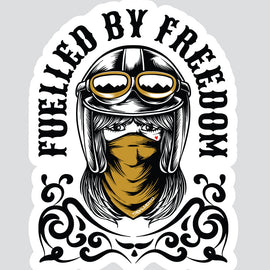 A die-cut sticker featuring a stylized illustration of a woman in a black aviator helmet with goggles and a mustard yellow bandana, with the text 'FUELLED BY FREEDOM' arched above her on a light gray background.