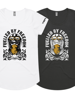 Two women's short-sleeve graphic T-shirts shown on a plain white background, one white and one black. Each shirt features a large front graphic of a biker-style face with a helmet and the text 'FUELLED BY FREEDOM' around it.