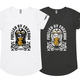 Two women's short-sleeve graphic T-shirts shown on a plain white background, one white and one black. Each shirt features a large front graphic of a biker-style face with a helmet and the text 'FUELLED BY FREEDOM' around it.