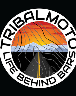 Design of a sunset with road and mountains, layered with topography lines and surrounded by the words TribalMoto Life behind bars on a decal