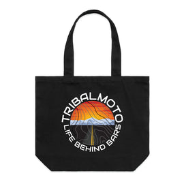 circle design includes the words TribalMoto and Life Behind Bars with a sunset, mountains and a road. Layered with topographical lines on black tote wide