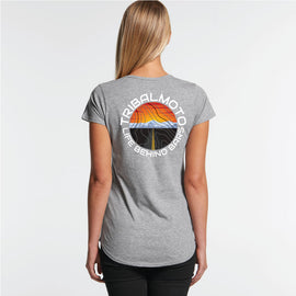 Design of a sunset with road and mountains, layered with topography lines and surrounded by the words TribalMoto Life behind bars on a grey tee