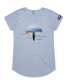 This design is of a motorbike in front of a beautiful sunset on ladies blue marl tee