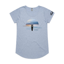 This design is of a motorbike in front of a beautiful sunset on ladies blue marl tee