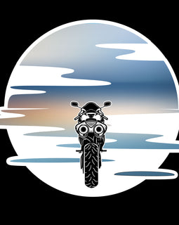 Motorbike riding into a blue and orange sunset