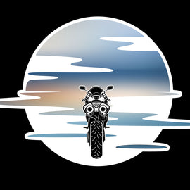 Motorbike riding into a blue and orange sunset