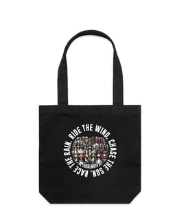 Black tote bag with a design of motorcycle lady riders and the words Ride the wind, Chase the sun, Race the rain in a circle around the outside.